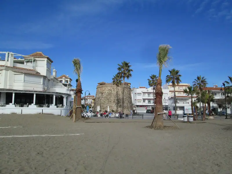 La Cala de Mijas beach with palm trees and the old watchtower