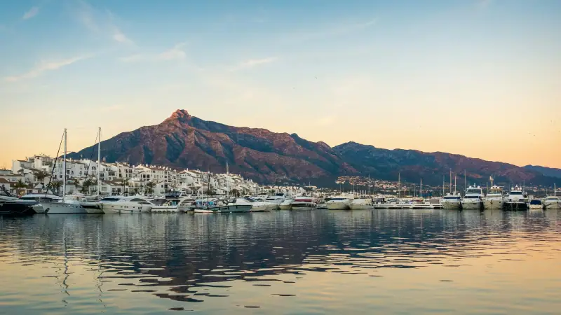Puerto Banús marina at golden hour with La Concha mountain behind