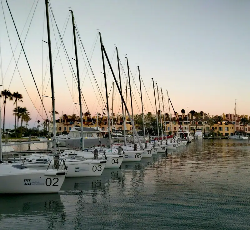 Sailing boats moored in Sotogrande marina at dusk